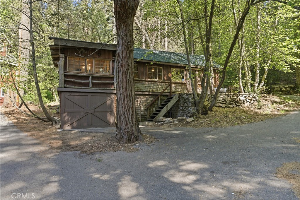 815 Cottage Grove Road Lake Arrowhead, CA 92352 - Photo 4 of 46 a yellow house with trees in front of it