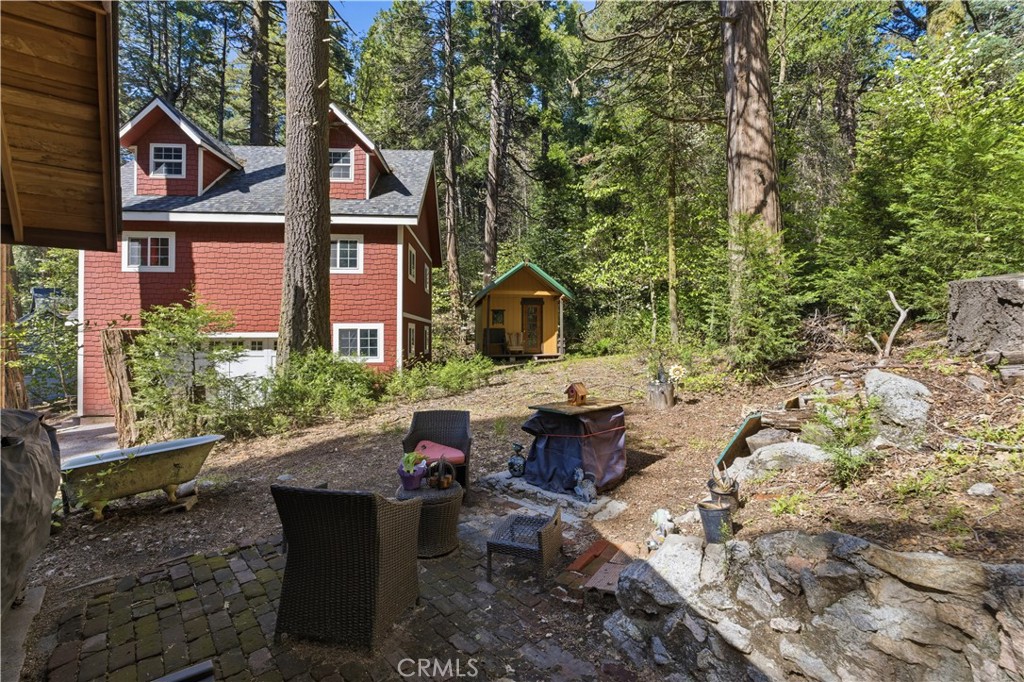815 Cottage Grove Road Lake Arrowhead, CA 92352 - Photo 42 of 46 a view of a house with backyard and sitting area