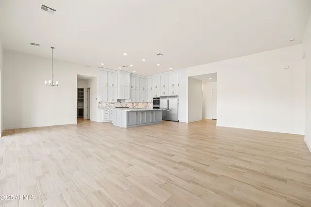 a view of an empty room and window with a floor to ceiling window