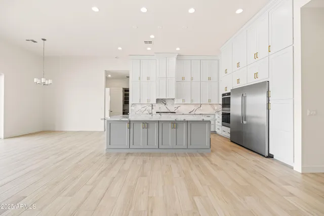 a kitchen with granite countertop white cabinets and sink