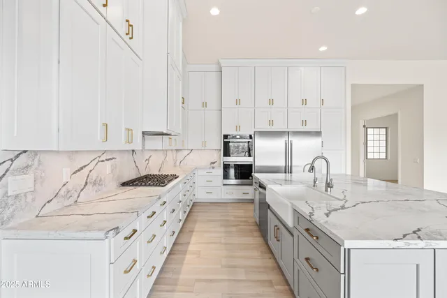 a spacious bathroom with a granite countertop sink mirror and shower