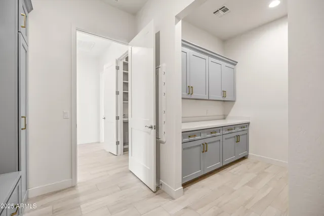 an empty room with wooden floor and a window
