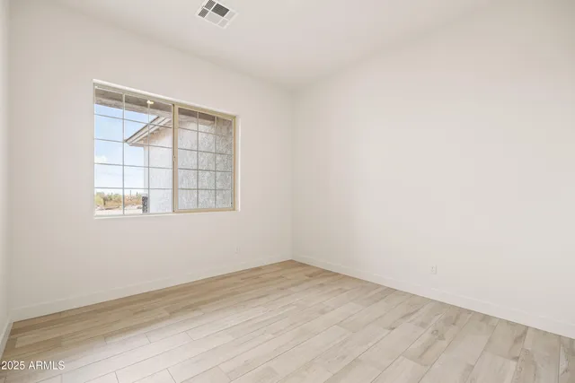 an empty room with wooden floor