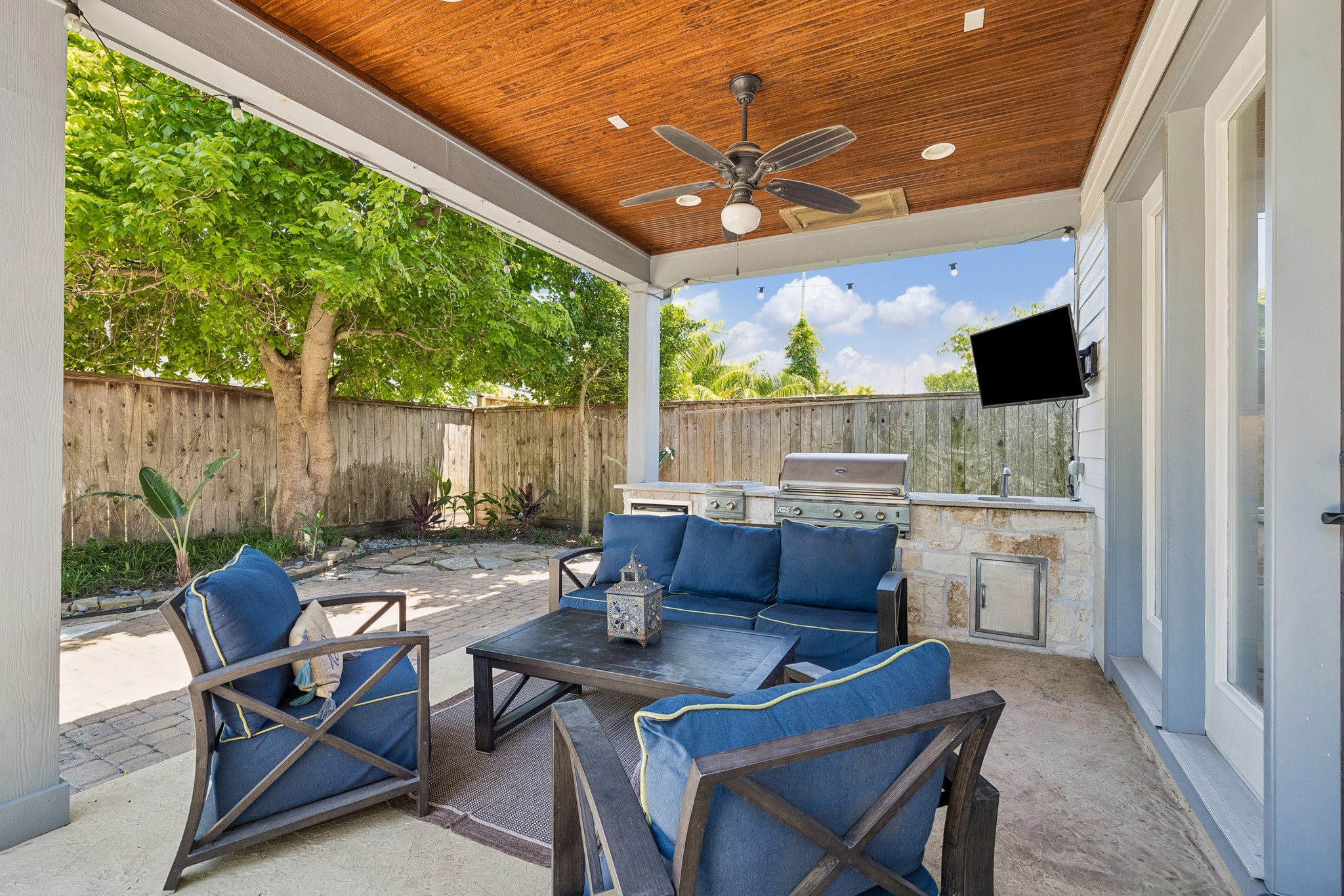 1360 Chippendale Road Houston, TX 77018 - Photo 28 of 34 Exceptional covered outdoor living area designed for year-round entertaining and everyday enjoyment. Features a beadboard ceiling, recessed lighting, ceiling fan, outdoor TV, built-in RCS stainless steel grill, two burners, beverage refrigerator, sink, and granite countertops.