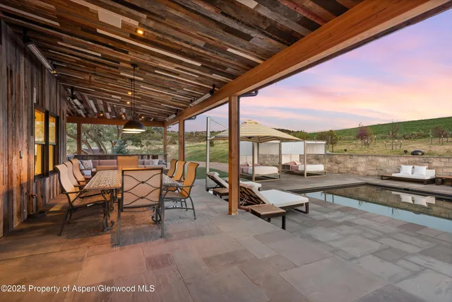 an outdoor space with patio couches and a fireplace