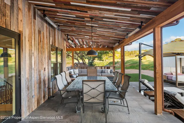 a view of a terrace with couches and wooden floor