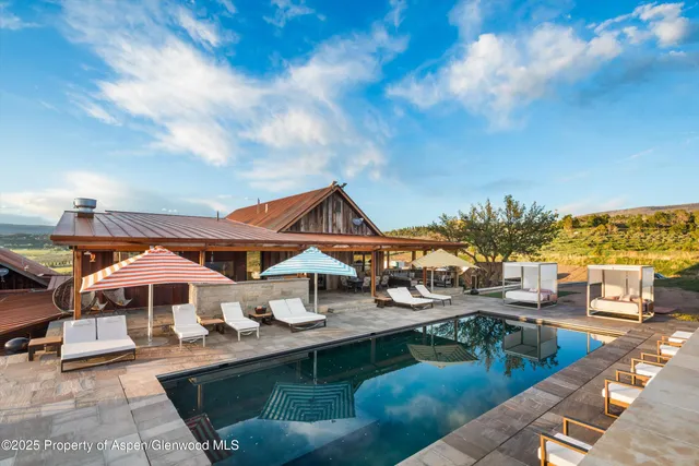 a dining room with stainless steel appliances kitchen island granite countertop a dining table and chairs