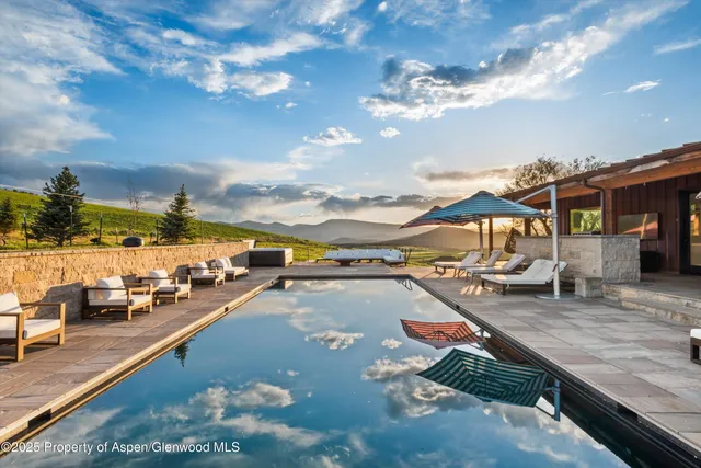 a view of a table and chairs in the garden