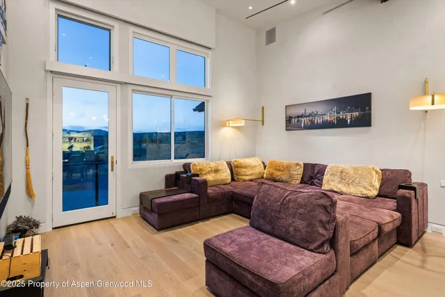 a living room with a couch and a chandelier