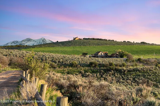 an aerial view of a house with garden space and outdoor seating