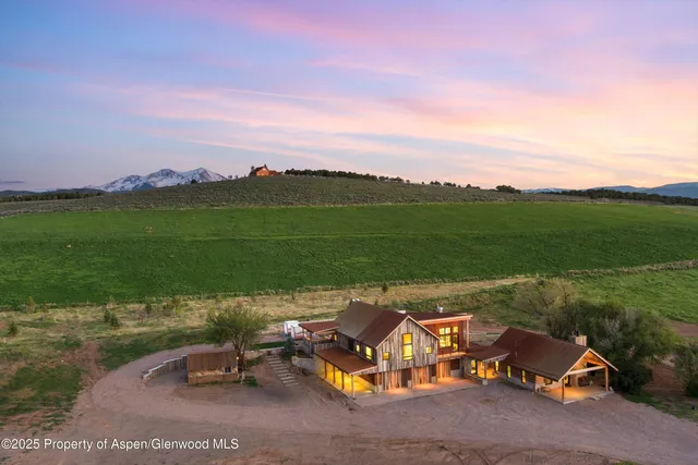 a view of a swimming pool with a table and chairs in the patio