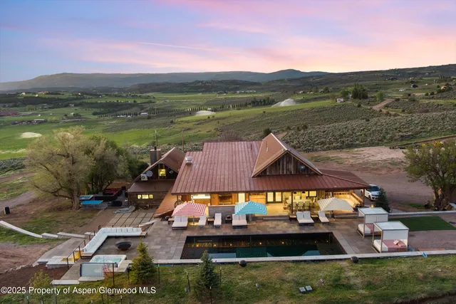 a dining room with furniture and a floor to ceiling window