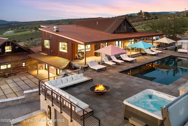 a view of a terrace with lawn chairs