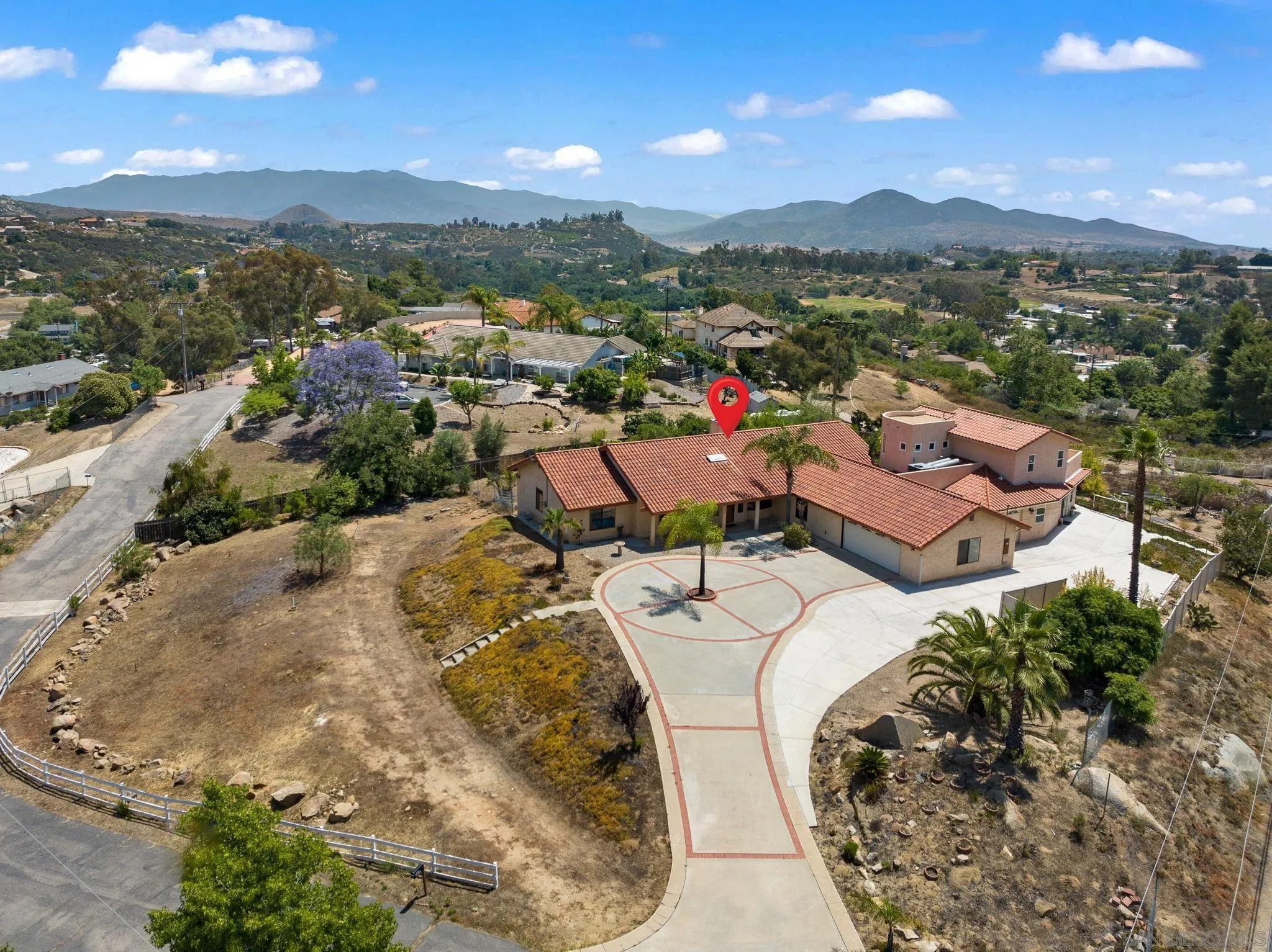 an aerial view of a house with a mountain view
