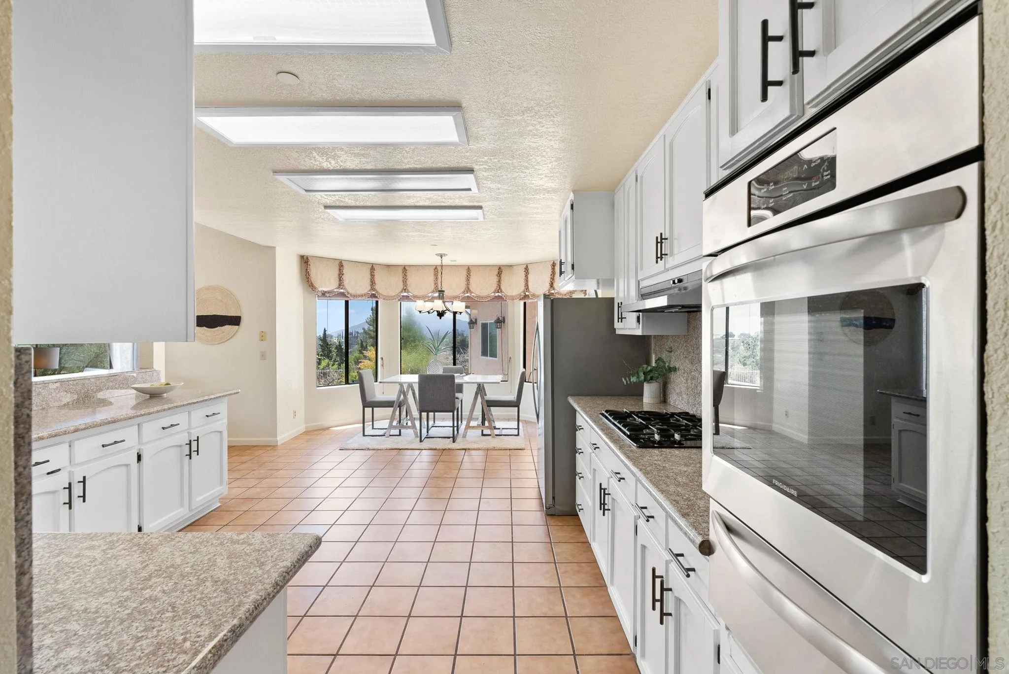 3290 Quail Way Jamul, CA 91935 - Photo 24 of 73 a kitchen with granite countertop a stove a sink and a refrigerator