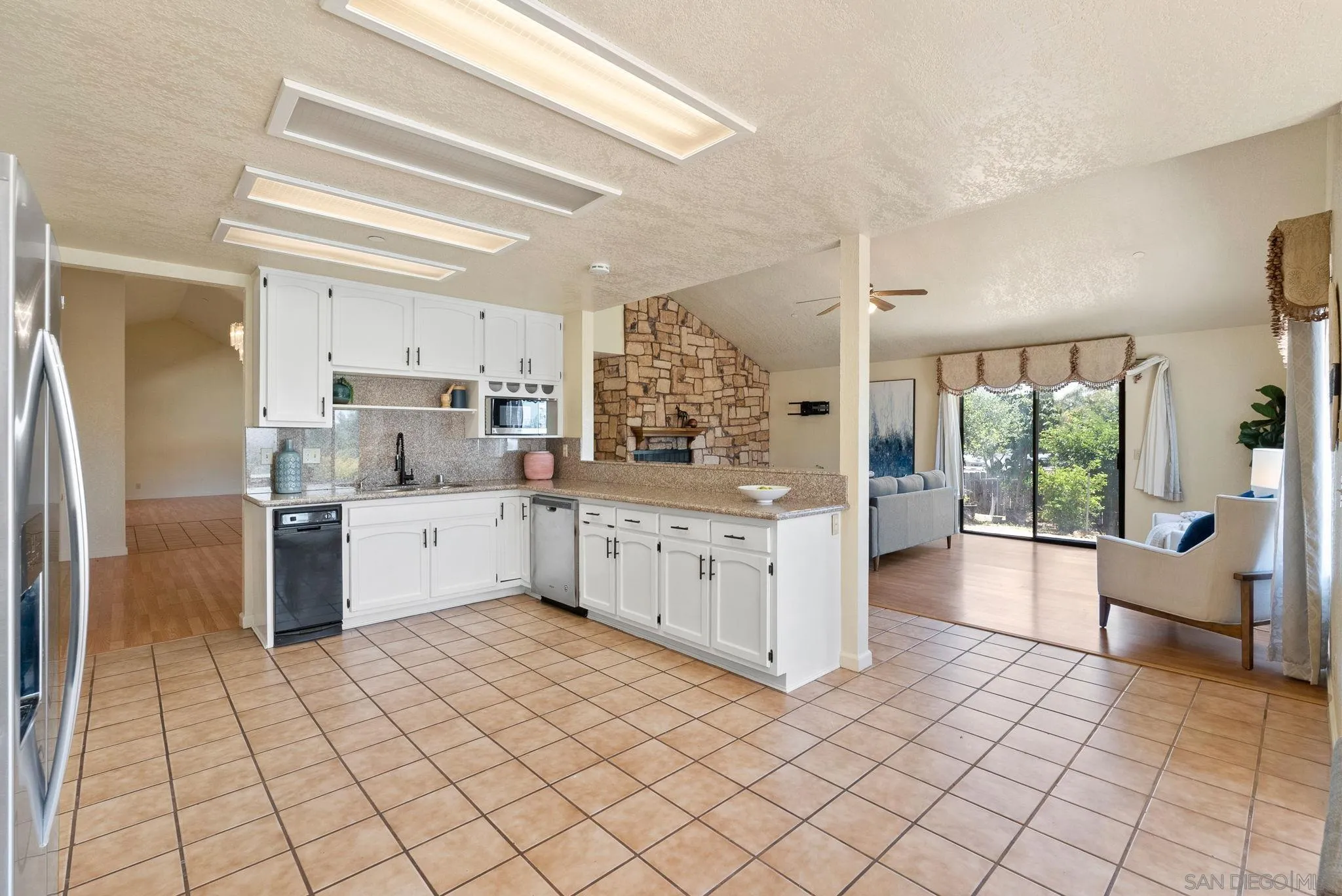 3290 Quail Way Jamul, CA 91935 - Photo 27 of 73 a kitchen with stainless steel appliances a refrigerator sink and cabinets