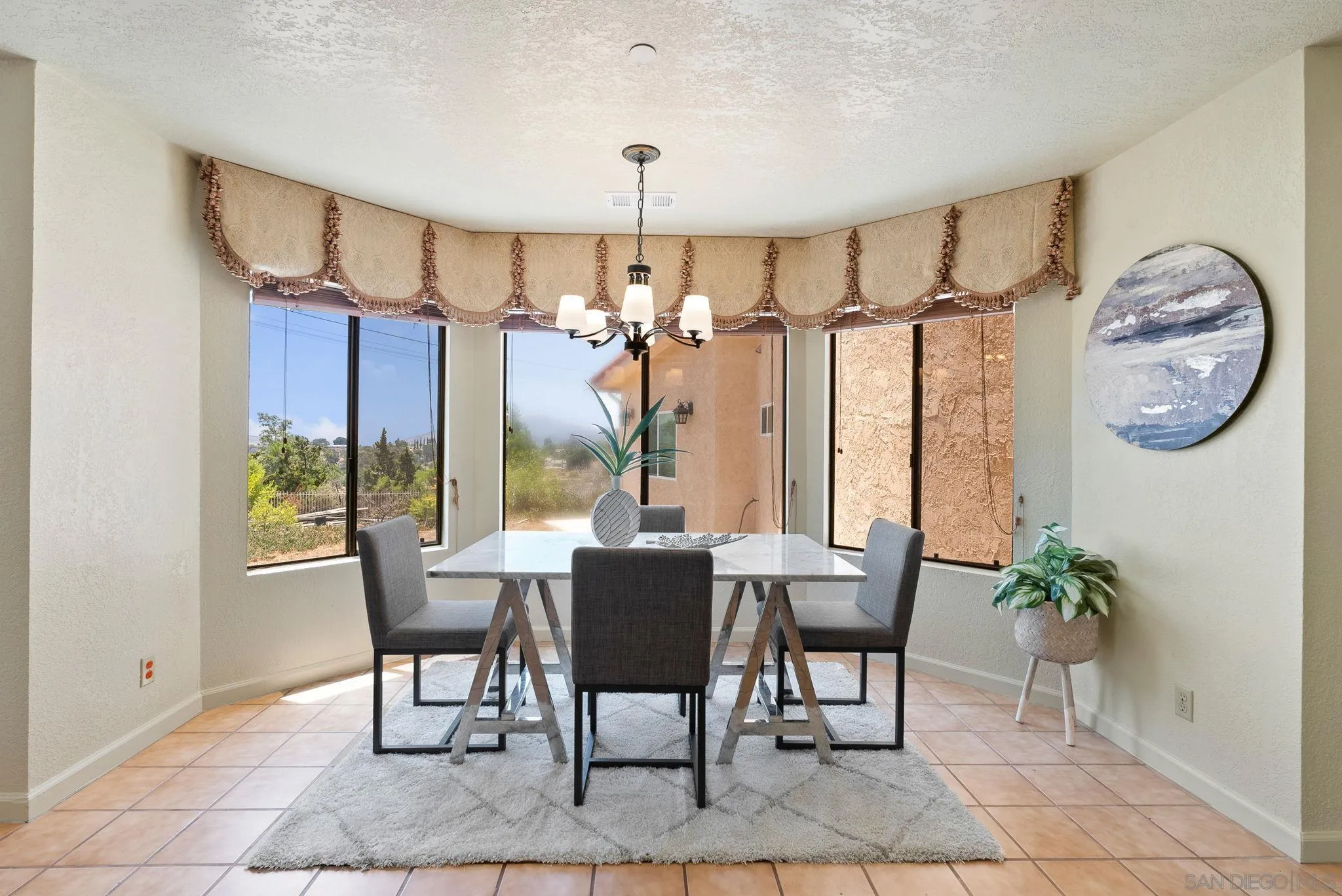 3290 Quail Way Jamul, CA 91935 - Photo 29 of 73 a dining room with furniture a chandelier and a rug