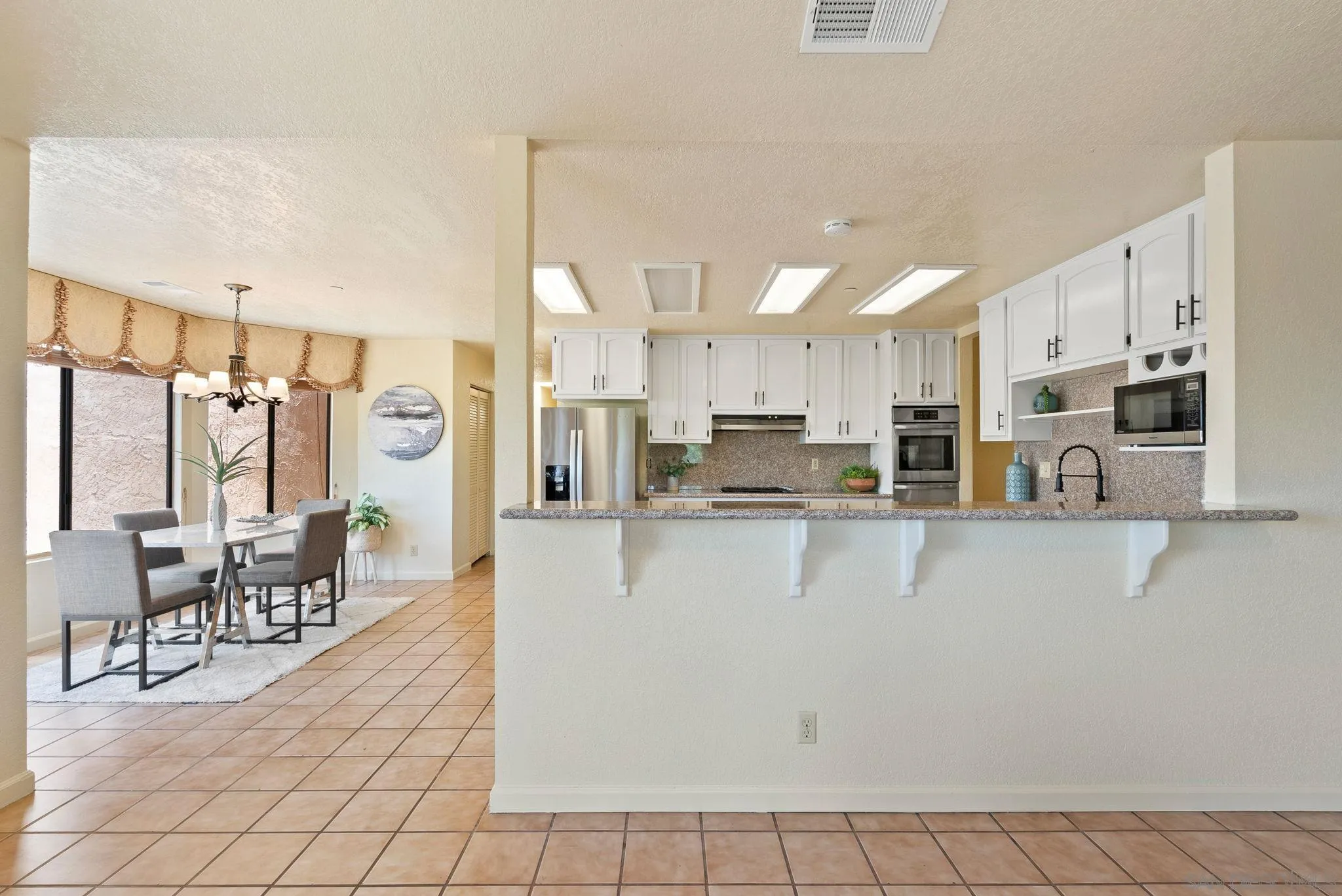 3290 Quail Way Jamul, CA 91935 - Photo 31 of 73 a view of a kitchen with kitchen island stainless steel appliances refrigerator sink and cabinets