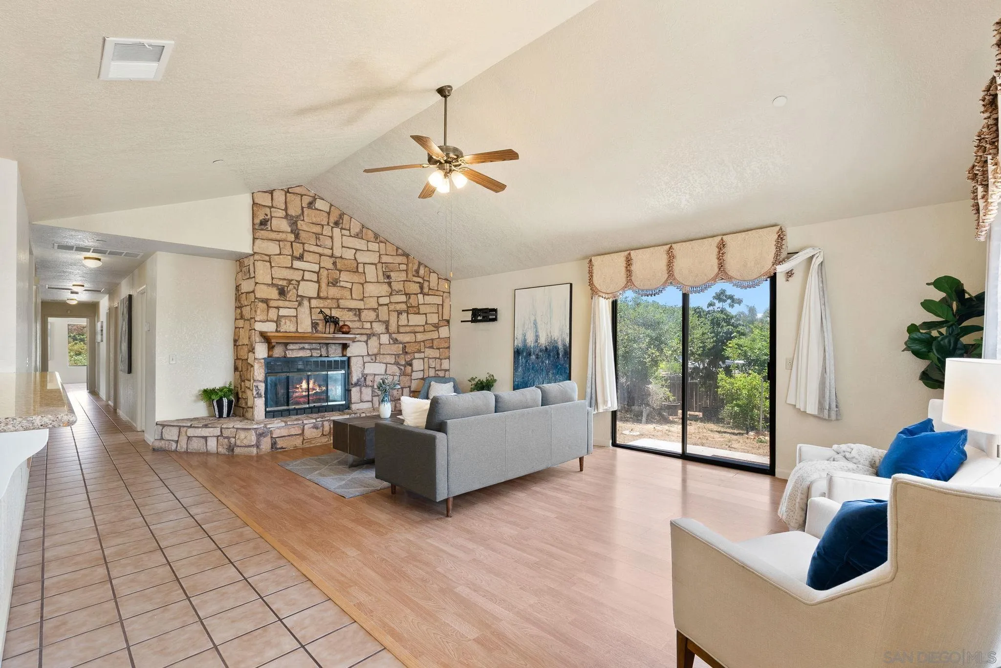 3290 Quail Way Jamul, CA 91935 - Photo 33 of 73 a living room with fireplace furniture and a large window