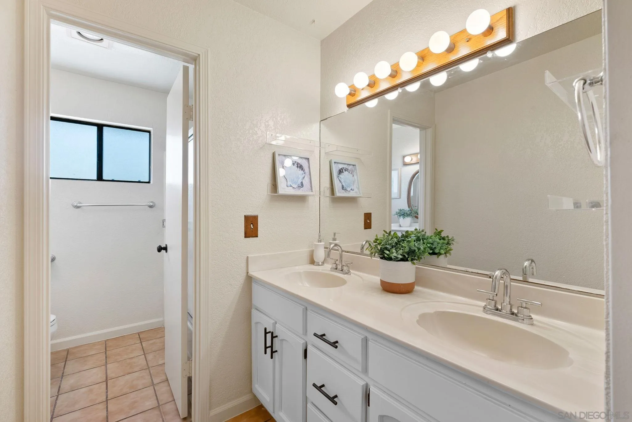 3290 Quail Way Jamul, CA 91935 - Photo 38 of 73 a bathroom with a double vanity sink and a mirror