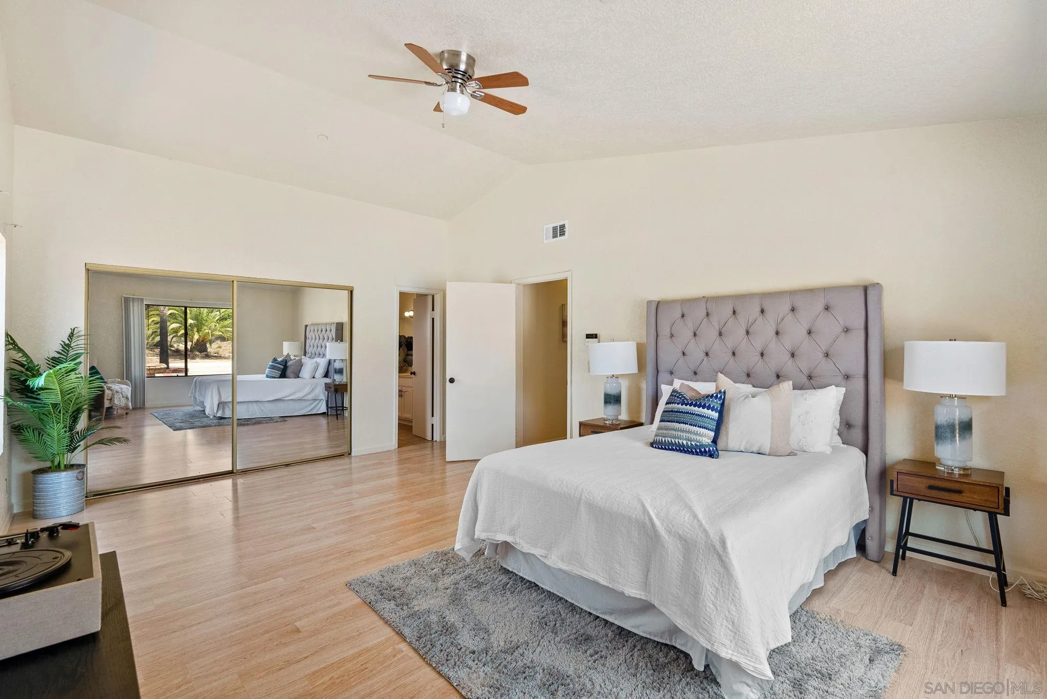 3290 Quail Way Jamul, CA 91935 - Photo 44 of 73 a spacious bedroom with a bed a couch and potted plant with the dresser