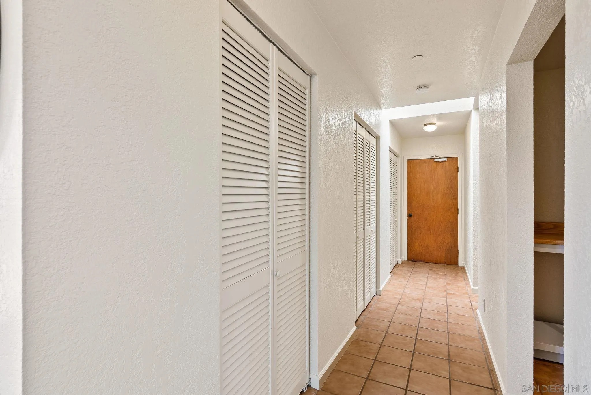 3290 Quail Way Jamul, CA 91935 - Photo 51 of 73 a view of a hallway with a chandelier