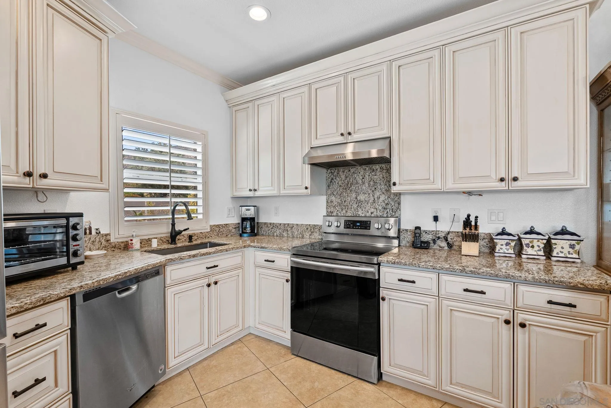 3290 Quail Way Jamul, CA 91935 - Photo 60 of 73 a kitchen with stainless steel appliances granite countertop a sink stove and cabinets