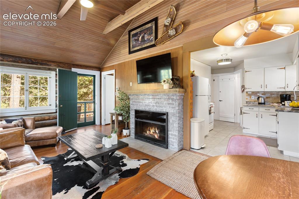 9120 Ute Road Cascade, CO 80809 - Photo 13 of 38 Vaulted ceilings, vintage chinking and a real log interior..with nice updates like a gas fireplace!