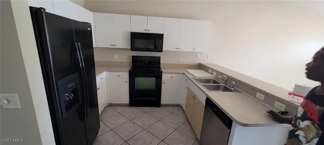 a kitchen with a refrigerator and a stove