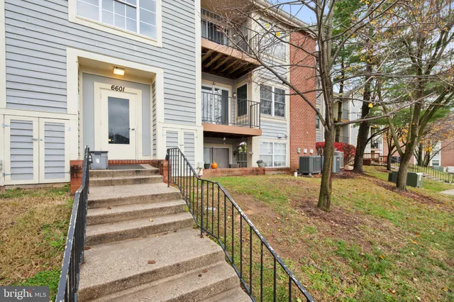 a view of a brick house with large windows and a table