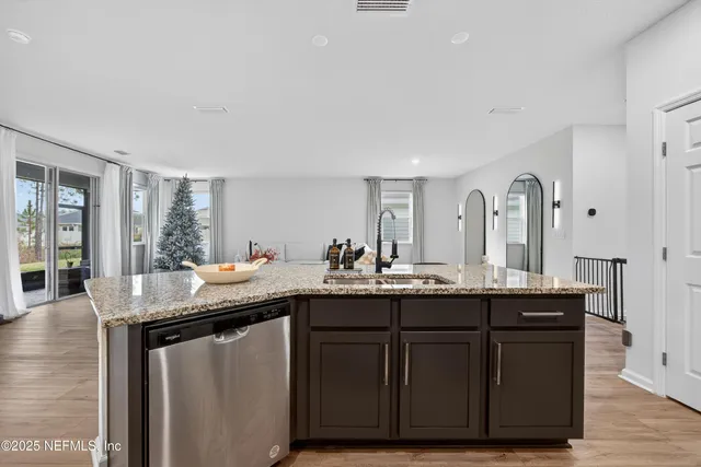 a dining hall with granite countertop a sink and wooden floor