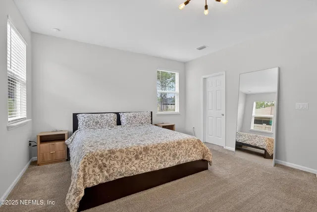 a bedroom with a bed and a cabinets