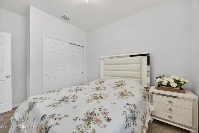 a bedroom with a bed and closet