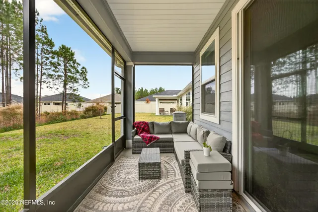 a balcony with furniture and garden view