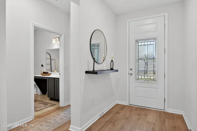 a view of a room with wooden floor cabinet and windows