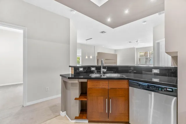 a kitchen with granite countertop a sink and cabinets