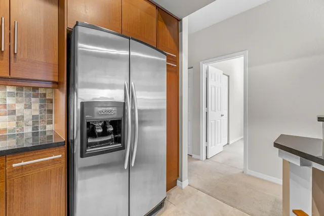 a kitchen with a refrigerator and a sink