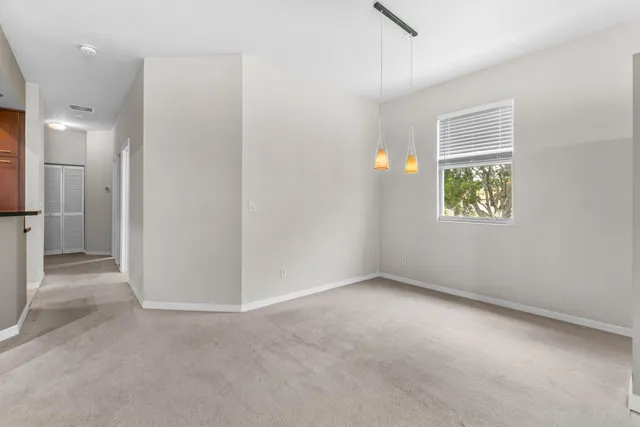 an empty room with windows and closet