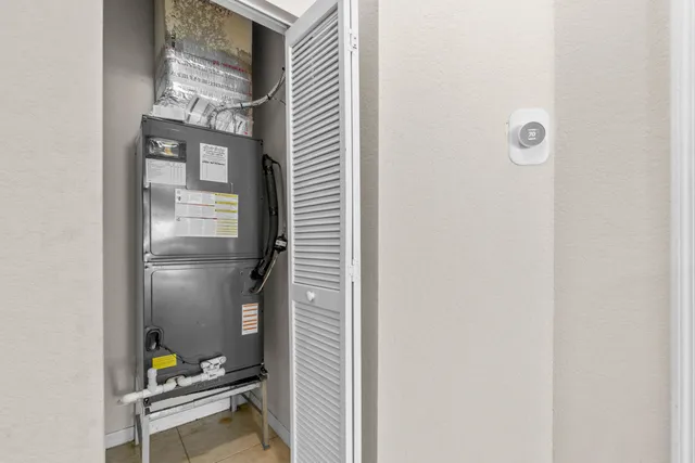 a hallway with painting on the wall and a window