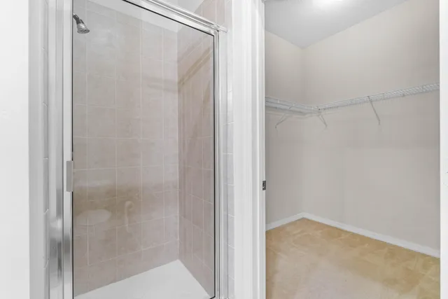a bathroom that has a glass shower door
