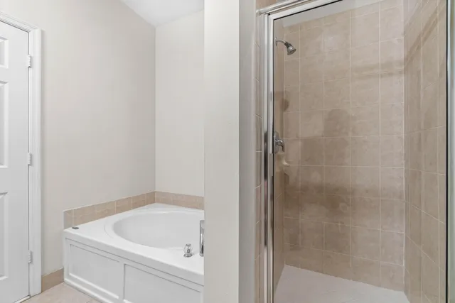 a bathroom with a tub and shower