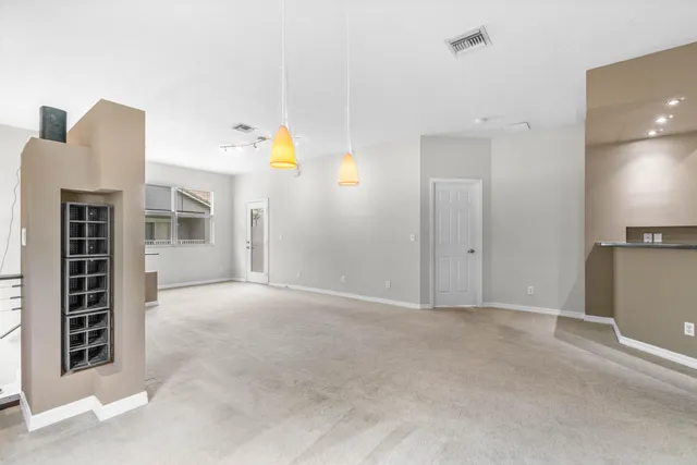 a view of an empty room with a kitchen