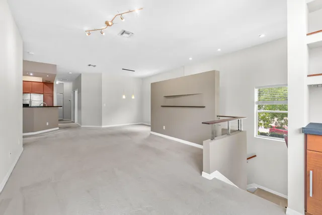 a view of a livingroom with furniture and a window
