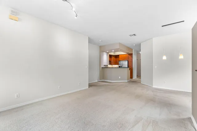 an empty room with a fireplace and windows