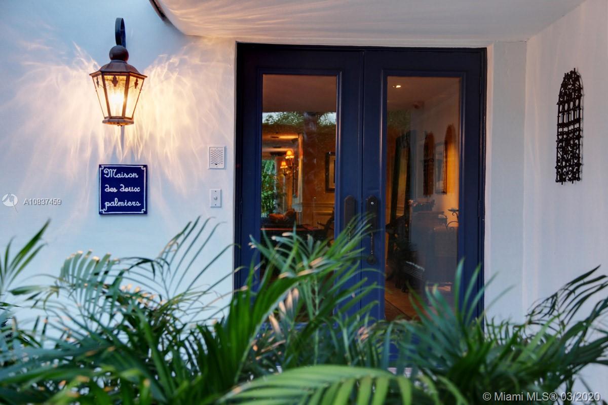 an entryway with a flower pot and a wooden door