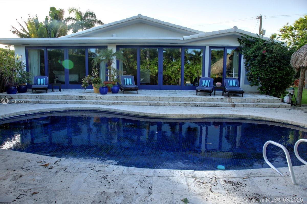 7975 Biscayne Point Circle Miami Beach, FL 33141 - Photo 13 of 34 a view of a house with a porch and a potted plant