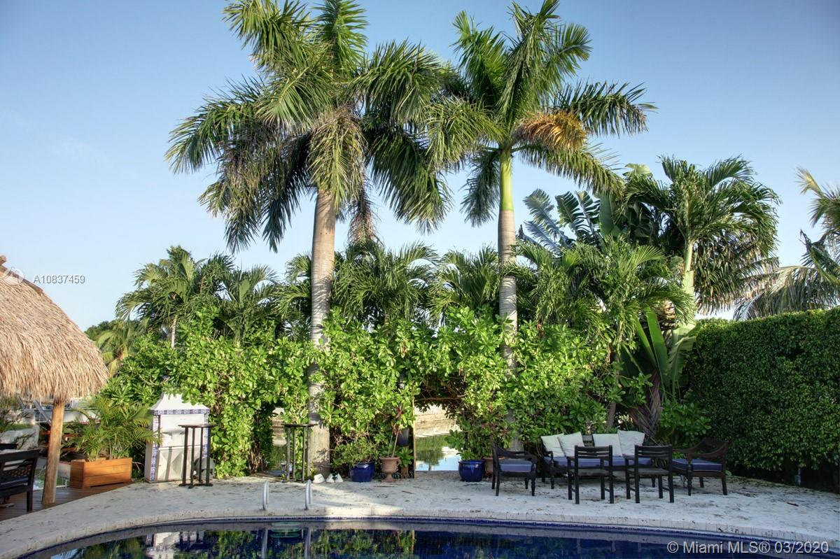 7975 Biscayne Point Circle Miami Beach, FL 33141 - Photo 15 of 34 a couple of palm trees sitting in front of house