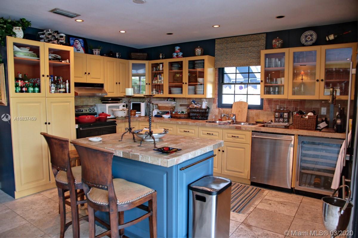 7975 Biscayne Point Circle Miami Beach, FL 33141 - Photo 19 of 34 a kitchen with a sink refrigerator and cabinets