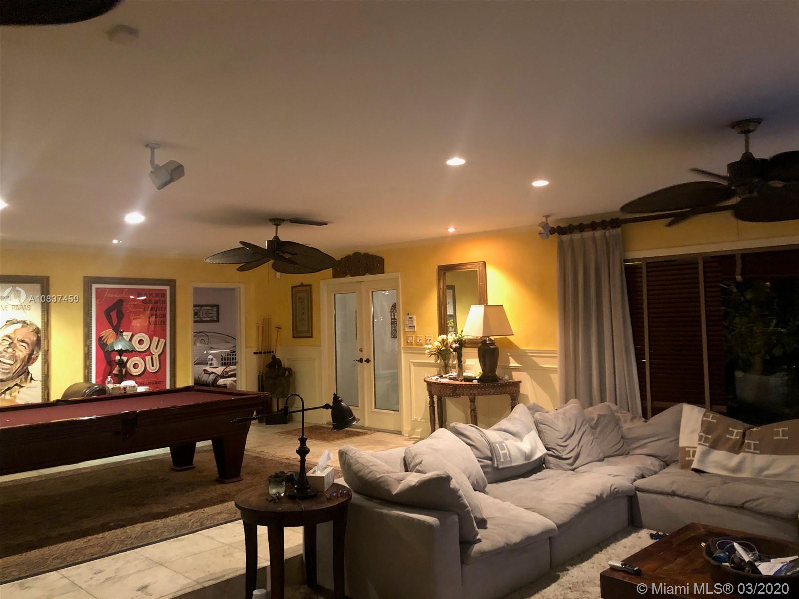 7975 Biscayne Point Circle Miami Beach, FL 33141 - Photo 22 of 34 a living room with furniture and a large window