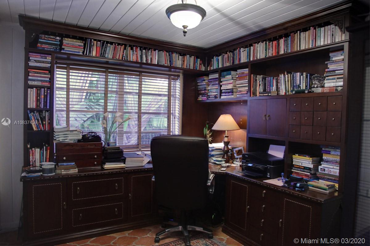 7975 Biscayne Point Circle Miami Beach, FL 33141 - Photo 24 of 34 a room with furniture a bookshelf and a window